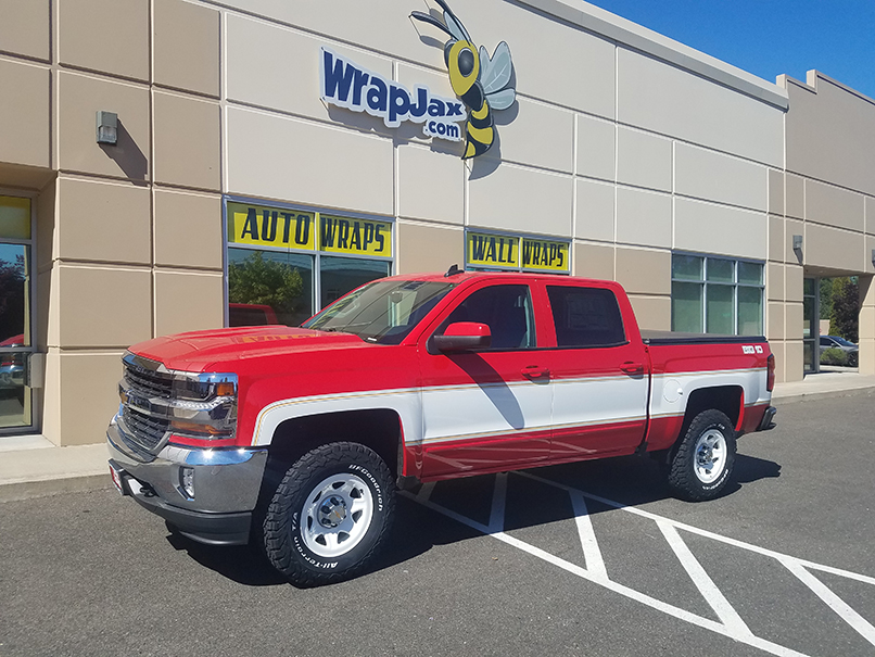 Partial gloss white wrap in retro design on red 2018 Chevrolet Silverado crew cab.